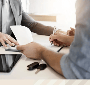 Person signing vehicle service contract